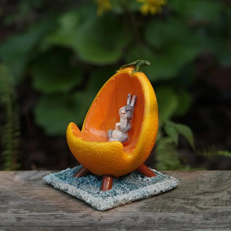 Orange - Shaped Phone Holder Resin Ornament. It Features a Design with an Orange as the Main Body and a Space Inside for Placing a Phone. The Shape Is Full of Creativity and Freshness,