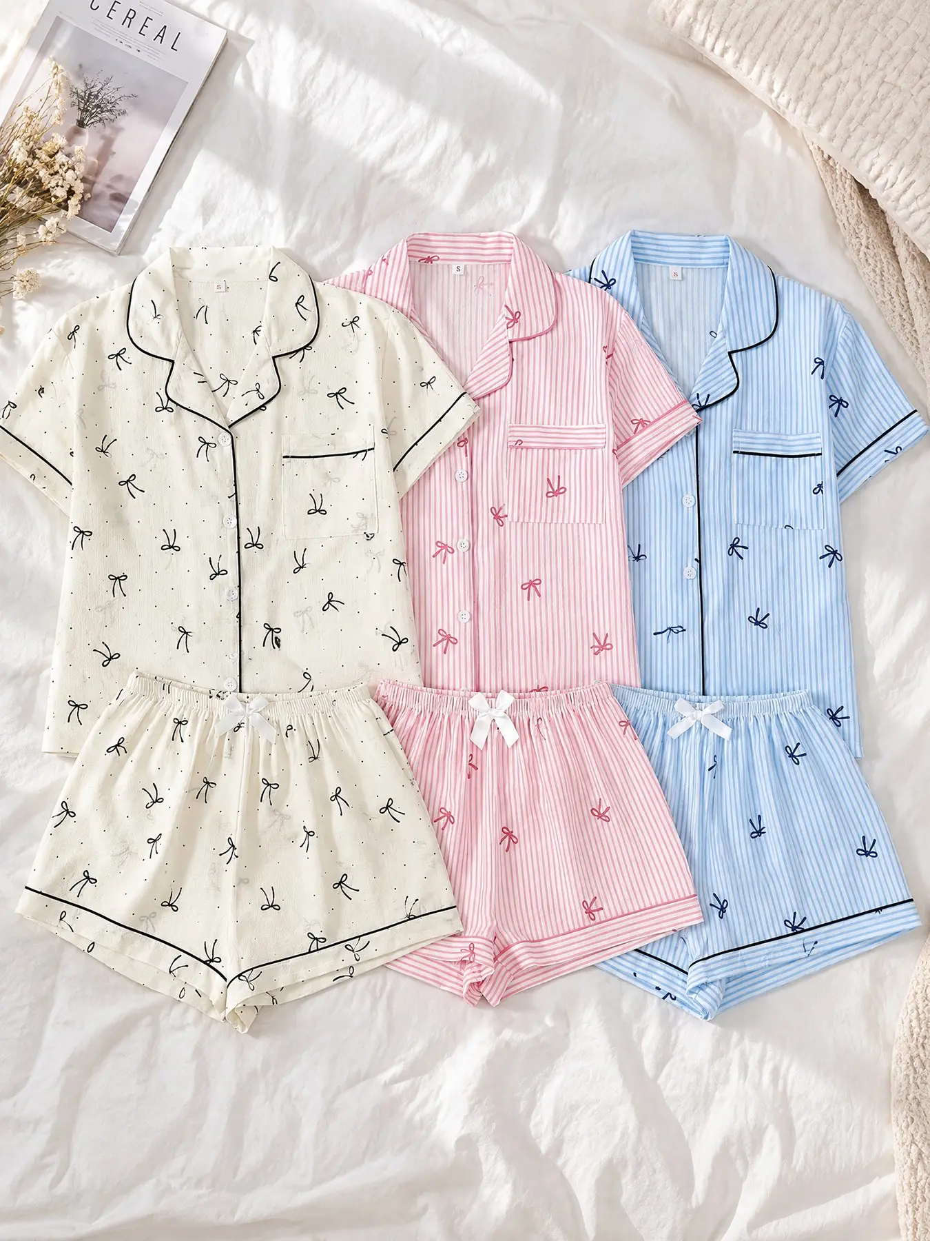 3 Pack Women Open Front Pajama Set, Short Sleeve Top & Shorts, Wearable All Seasons. Bow prints: cream base bow, pink stripe bow, blue stripe bow. Collared button tops match coordinating shorts, wearable separately for home rest and bedtime.