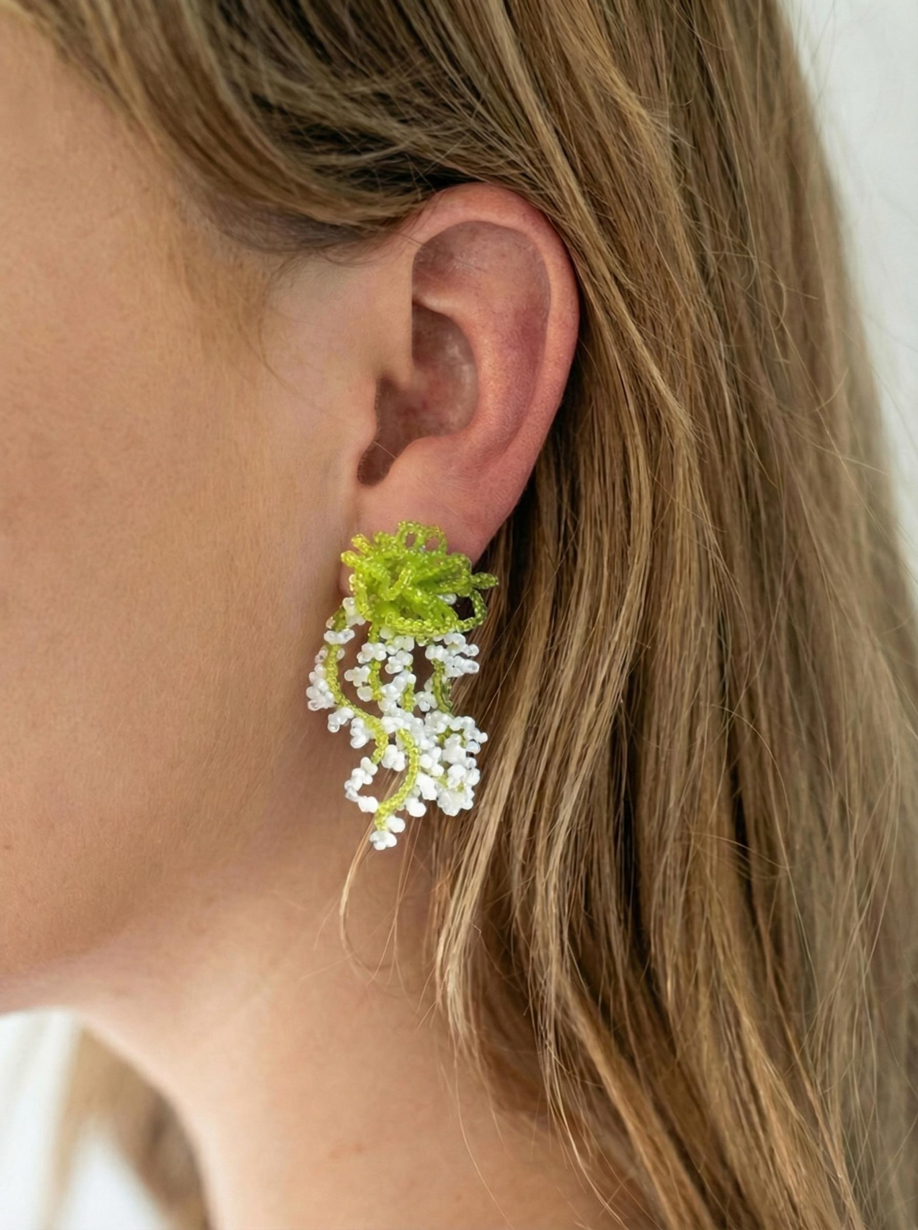 A pair of glass bead fringe earrings featuring a floral waterfall design, handcrafted earrings with a fresh, sweet style, perfect for a laid-back summer beach vacation look