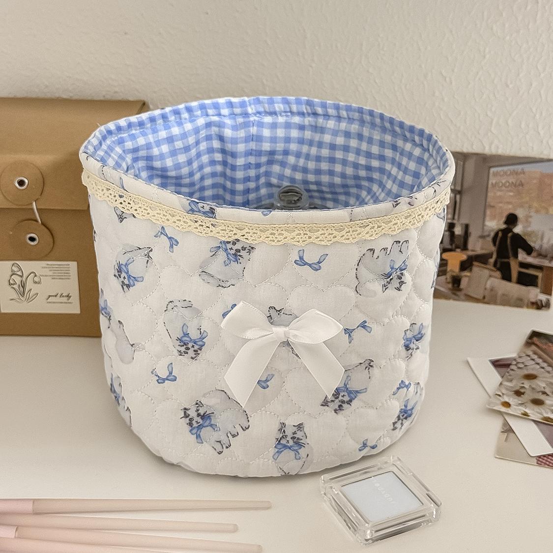 Cute lace bow patchwork storage basket, round fabric desktop organizer box, Instagram-style plaid print storage bin, soft padded makeup storage box, attractive pink bow storage bucket, foldable desktop storage basket
