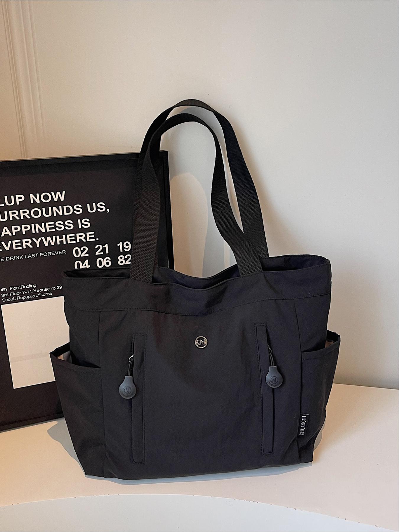 The large capacity soft commuter tote bag, is lightweight, spacious, suitable for daily use. It is a neutral waterproof nylon shoulder bag with a spacious interior suitable for 15 inch laptops, multiple side pockets, and a comfortable adjustab