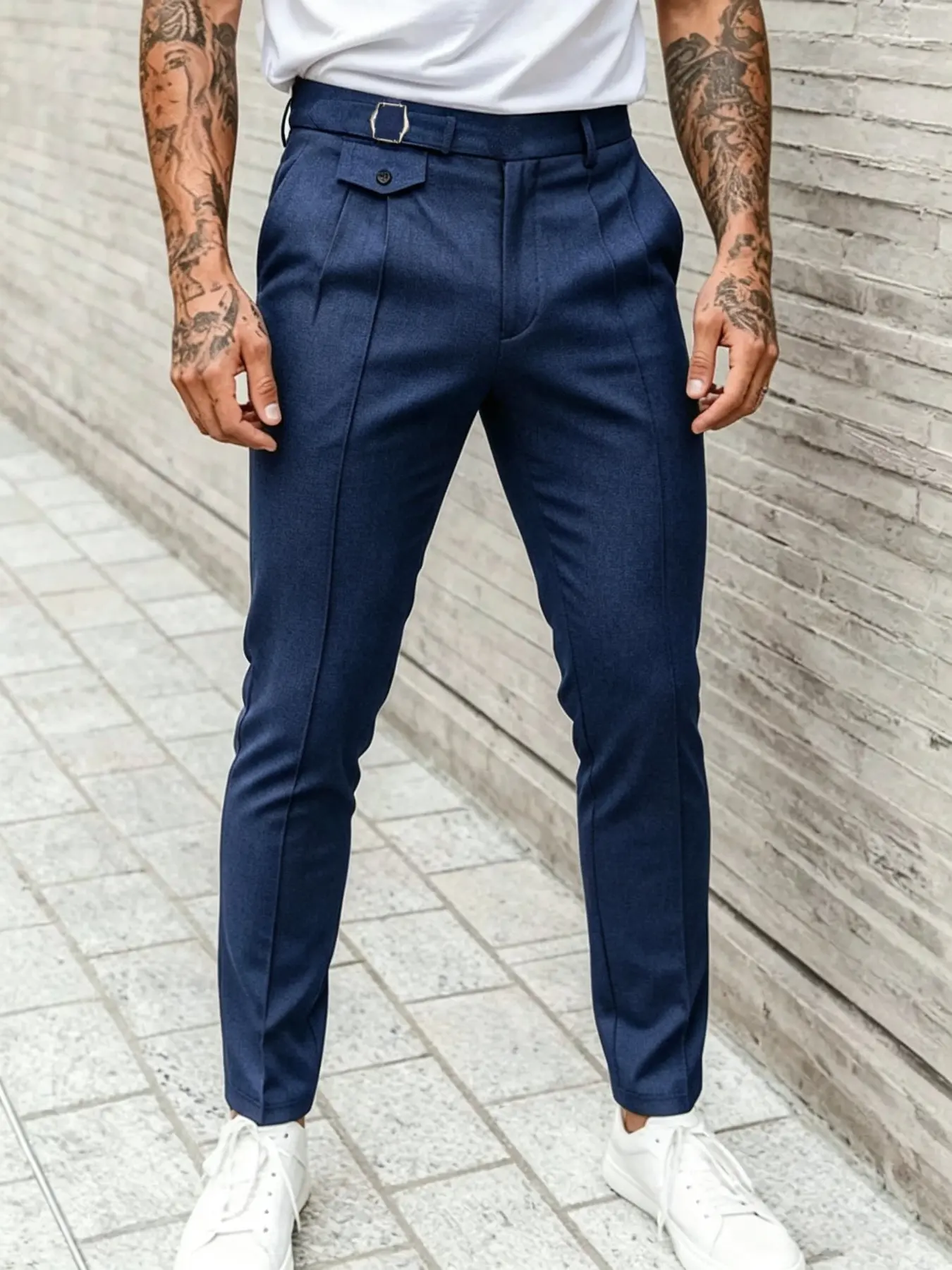 Men's minimalist suit trousers featuring a slim, tapered fit; suitable for both business and casual settings. Crafted from lightweight, breathable woven fabric, these are essential, understated trousers.