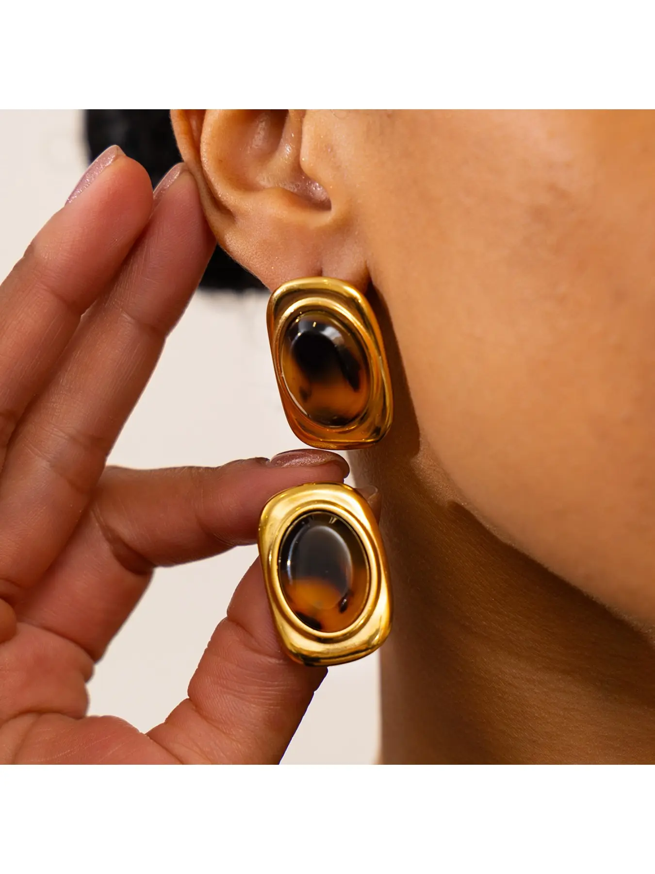 Geometric oval resin earrings featuring a unique, retro leopard-print design.