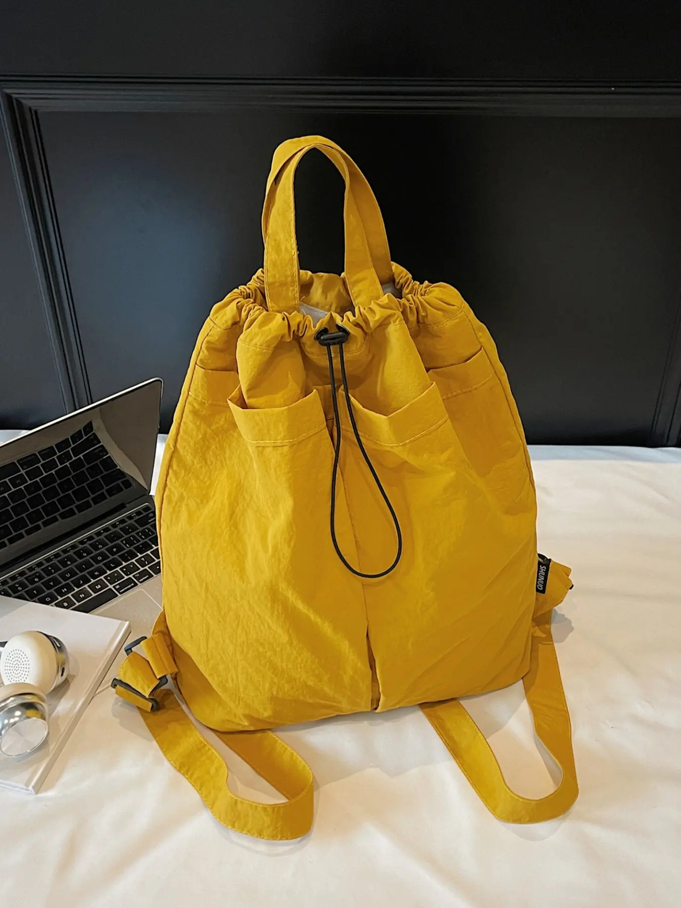 A solid color canvas backpack with a large capacity drawstring carrying bag, suitable for work, commuting. It is a versatile leisure backpack, Casual travel backpack, and a lightweight travel drawstring storage backpack. Back-to-school season