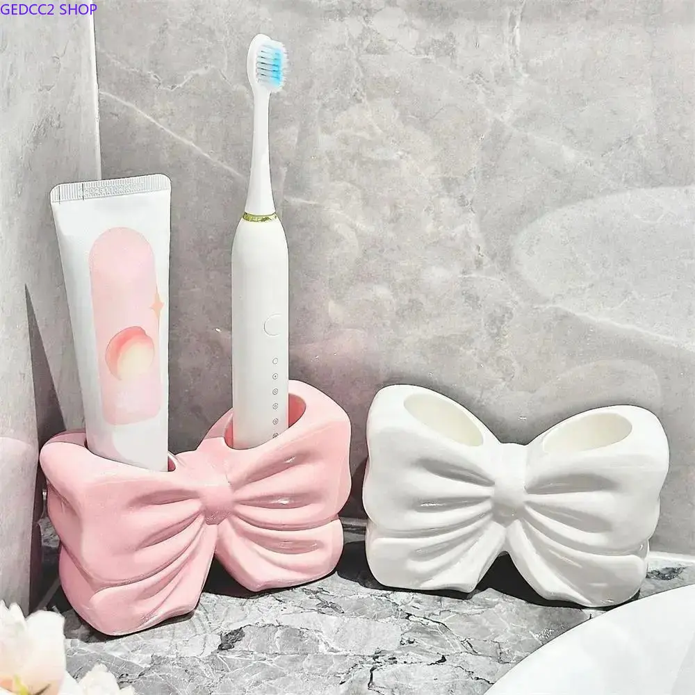 Adorable bowknot design ceramic toothbrush holder, multi-functional bathroom storage rack fits electric toothbrushes. Stylish decorative organizer suitable for household, dormitory and hotel use.