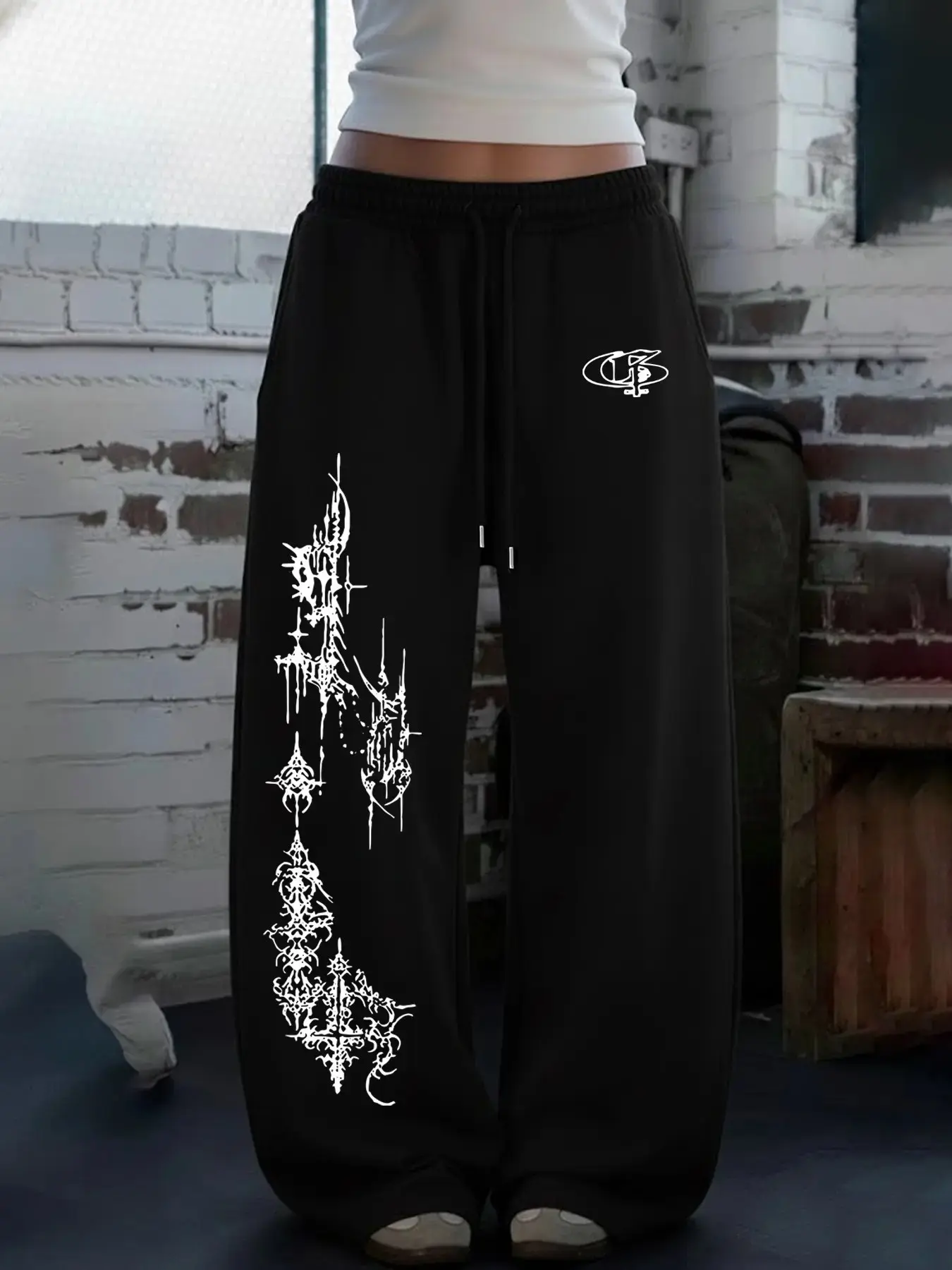 Women Alt Dark Punk Streetwear High Waist Full Elastic Drawstring Wide Leg Floor Length Sweatpants Soft Knit Solid Black Small Front Gothic Logo Large Left Side Long Spike Thorn Tribal Totem Graphic Loose Draped No Cuff Trouser For Skate Campus Music Fest