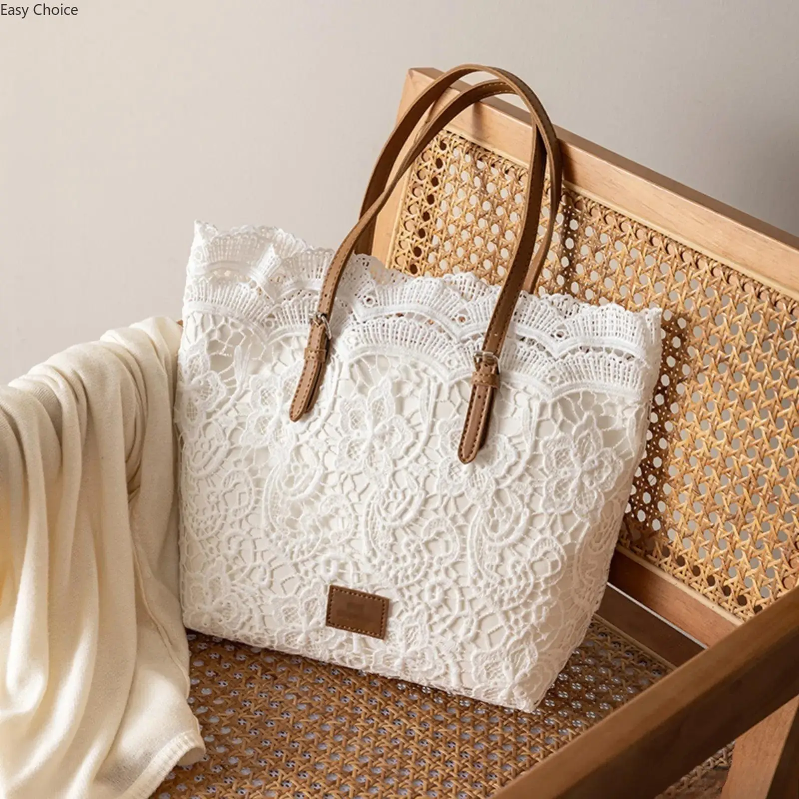 Women's Lace Crochet Beach Tote Bag with floral straps. Spacious knitted handbag, stylish and multi-functional. Ideal carryall for summer outings, vacations, travel and seaside activities.