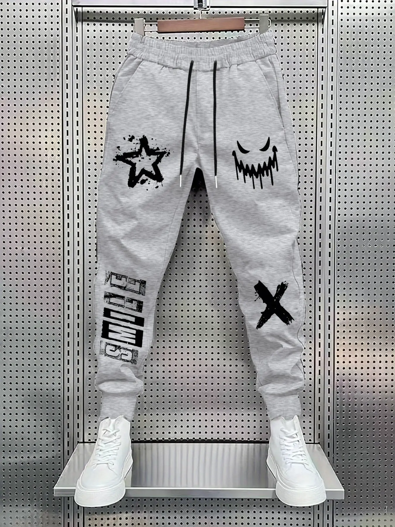Elastic Drawstring Jogger Pants, Graffiti Star Evil Grin Cross Letter Print Tapered Cuffed Ankle Streetwear Casual Sweatpants with Side Pockets #GraffitiJoggers #StreetwearPants #GraphicSweatpants #HipHopTrousers #TikTokMadeMeBuyIt