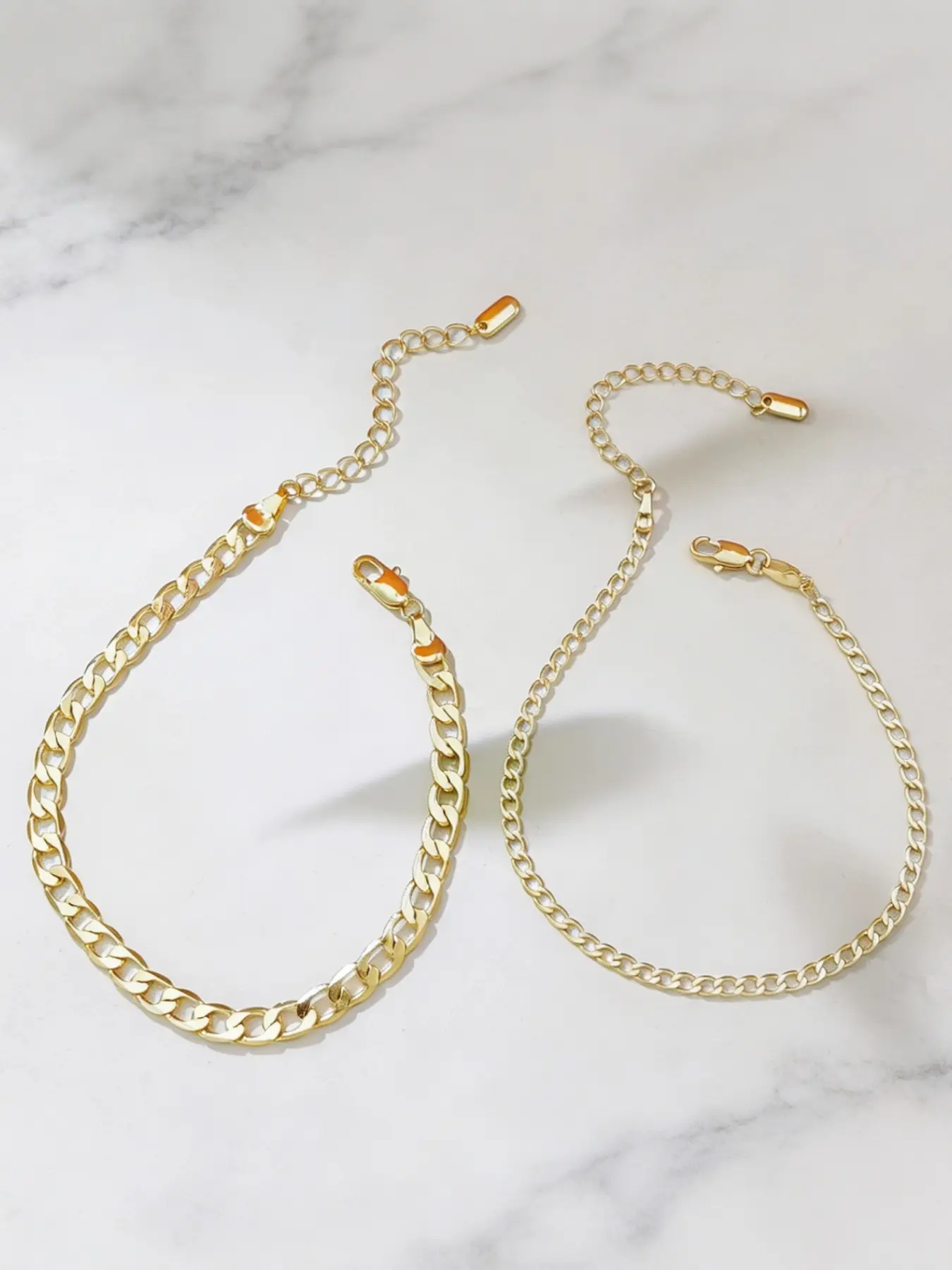 Ins-style double-layer Cuban ankle bracelets with a unique design; fine chains that can be worn layered around the ankle.