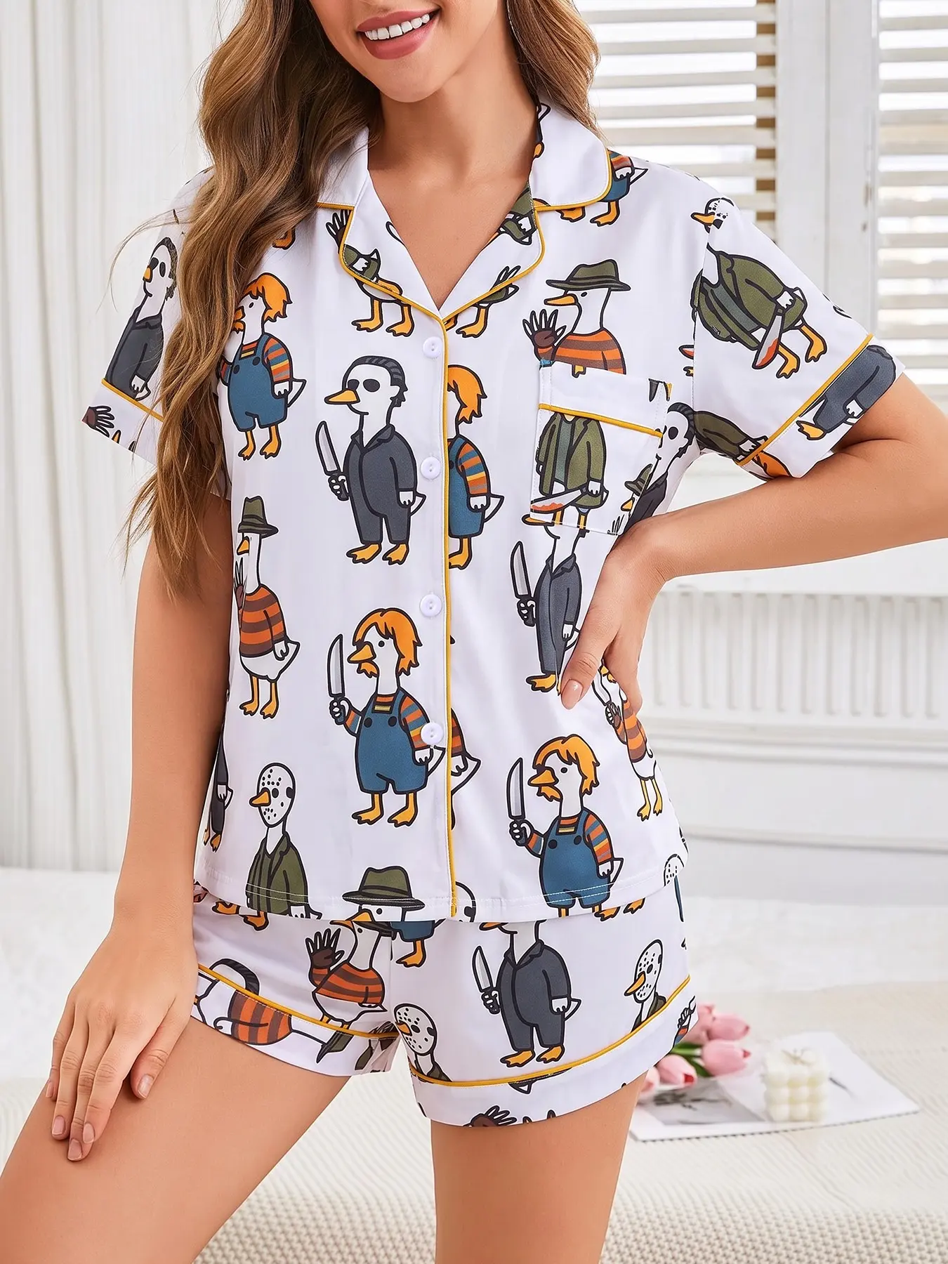 Women's 2-piece Halloween pajama set, white base with funny cartoon killer duck prints dressed as horror movie characters. Gold piping lapel top with pocket, elastic waist shorts, soft comfy playful loungewear for women all-season daily home wear