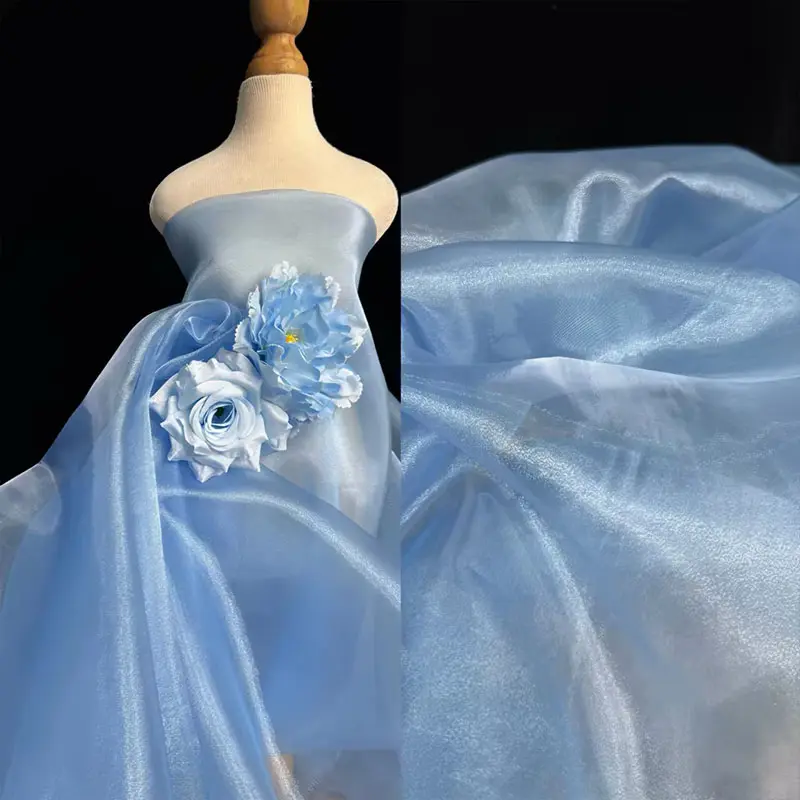 Blue shimmering sheer fabric, lightweight and breathable mesh material, suitable for DIY crafts, apparel, and wedding decorations