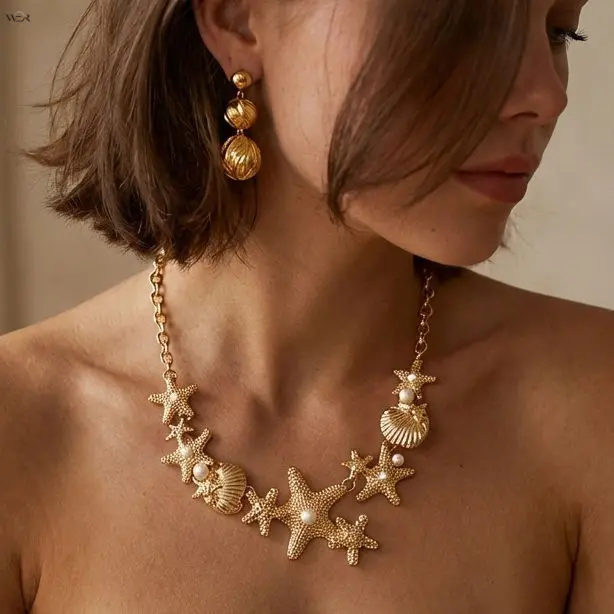 Women's Coastal Bib Necklace with Gold-Tone Starfish & Shell Cluster, Adjustable Faux Pearl Statement Jewelry for Summer Beach Trips, Bib Cluster, Oval Links, Beach Trip, Pearl Embellishments, Assorted Shell Necklace, Polished Metal, Adjustable Chain, Coa