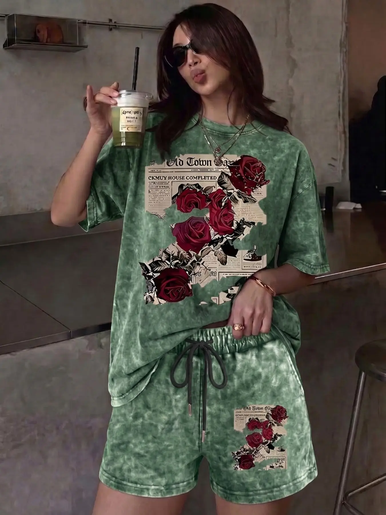 A relaxed, casual two-piece set featuring a floral rose-print tie-dye design; includes a crew-neck, short-sleeve washed T-shirt and drawstring shorts with pockets—perfect for outdoor leisure.