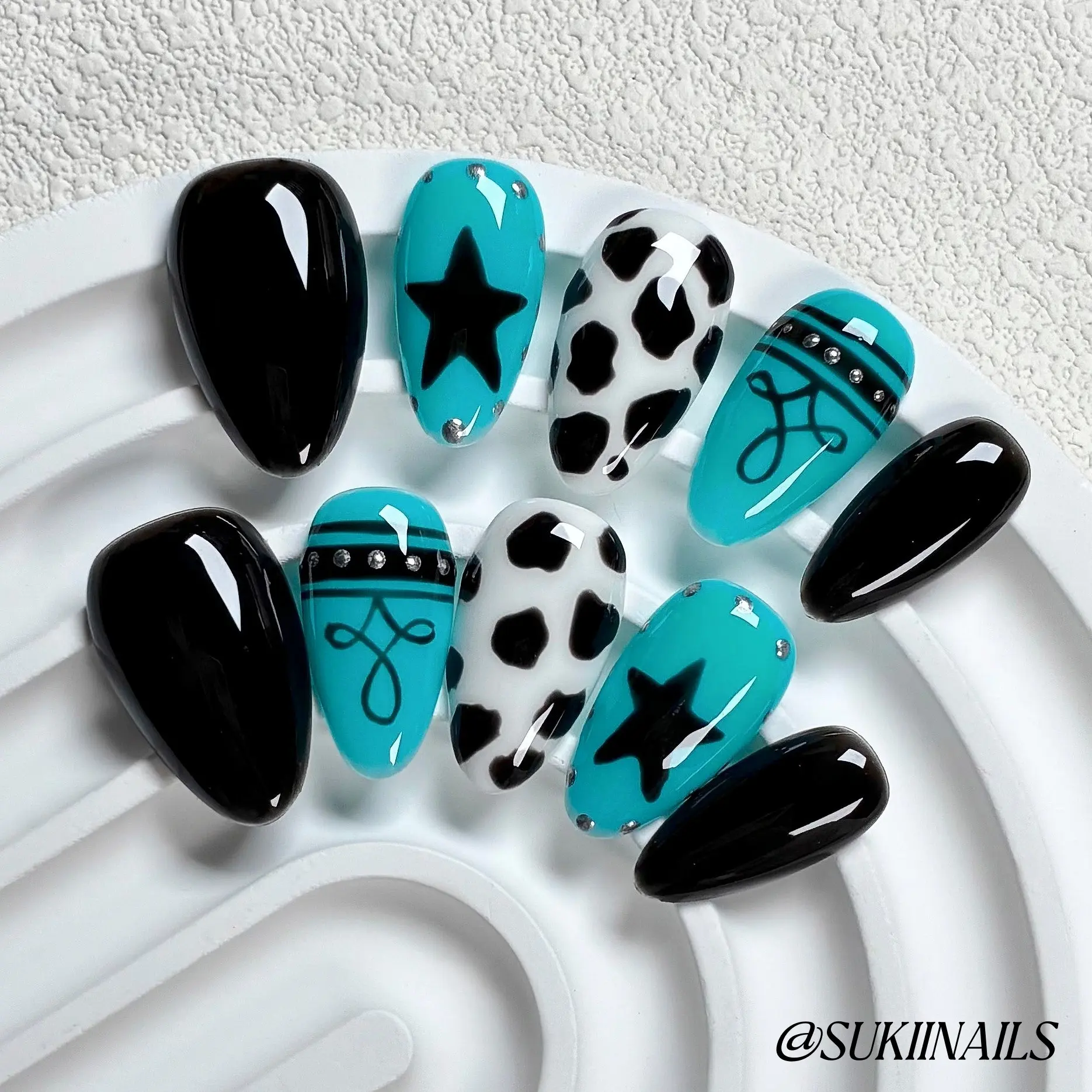 Y2K Cow Print Star Press On | Short Almond, 10pcs Handmade glossy nails with turquoise & black color block, cow spots, star & line art with tiny rhinestones, edgy reusable fake nails Decoration for street shots, live shows & alt markets