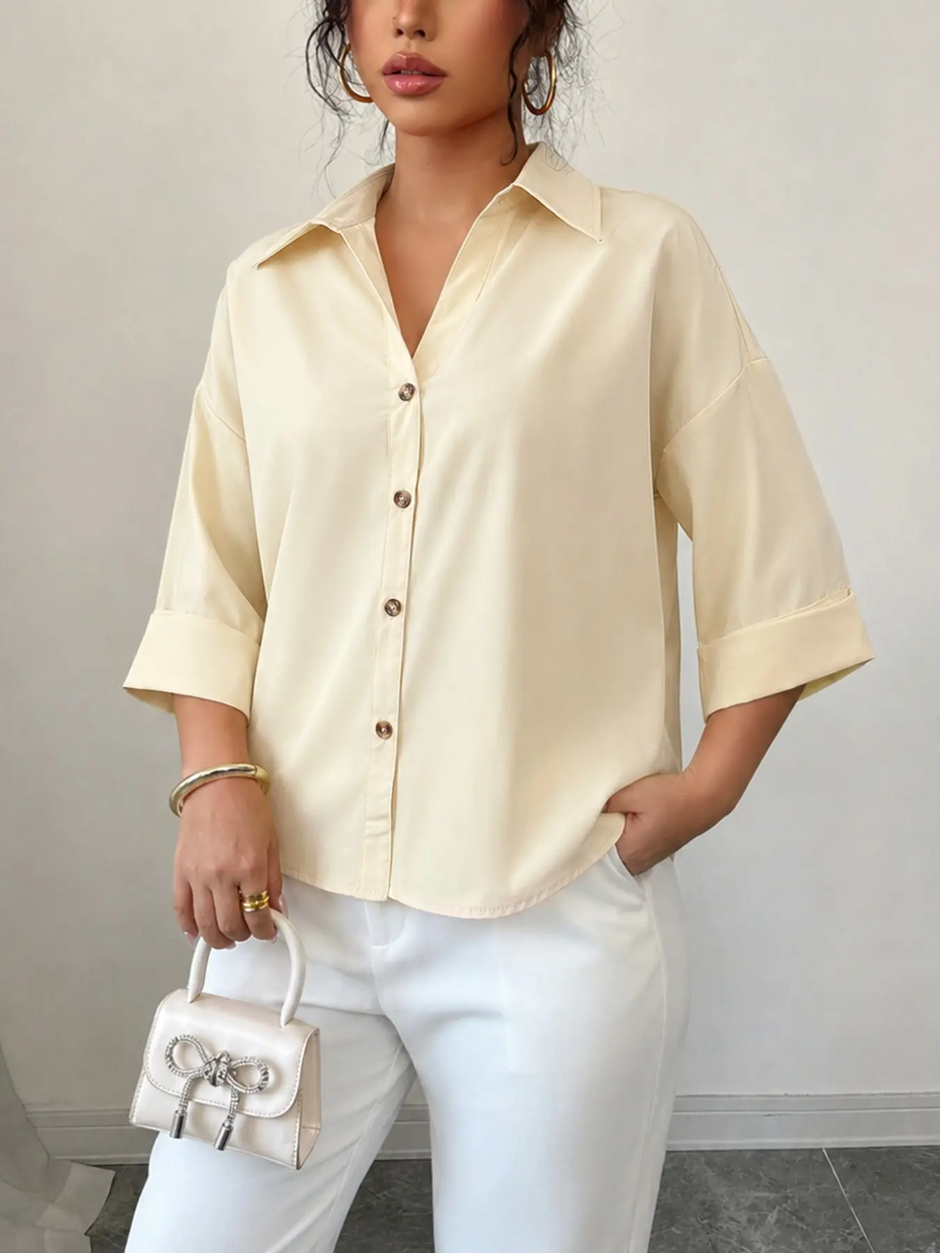 Relaxing milk yellow loose shoulder seven quarter sleeved Summer Shirt for women with V-neck rolled edge sleeves and a back slit design, a versatile Blouse Top for female office workers commuting, casual, leisure, going out for vacation, and looking slim