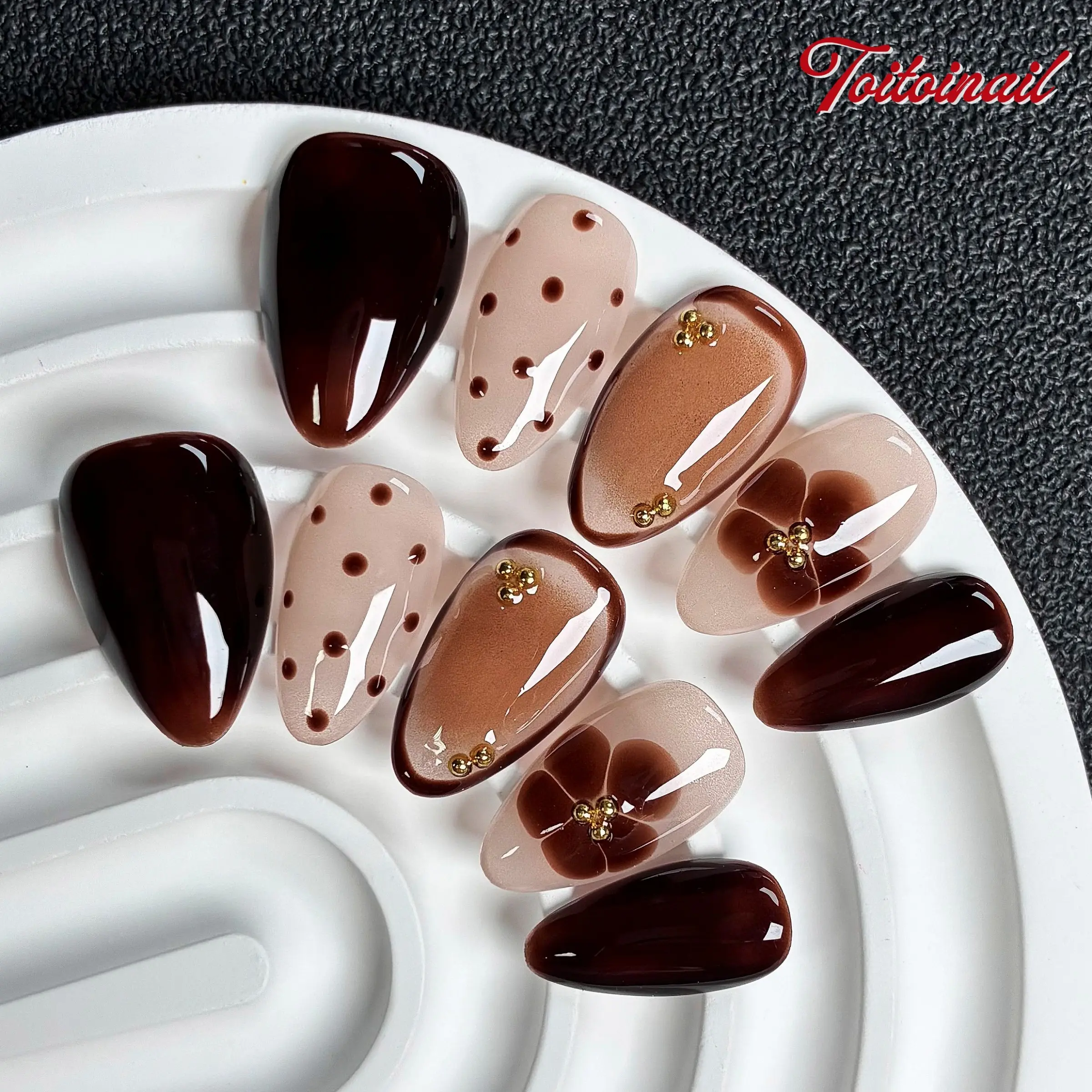 Mocha Floral Handmade Press Ons Nails | Short Almond, 10pcs glossy nails with solid dark coffee, sheer nude polka dot, mocha gradient & translucent flower print, mini gold bead studs, warm retro reusable fake nails for autumn daily wear