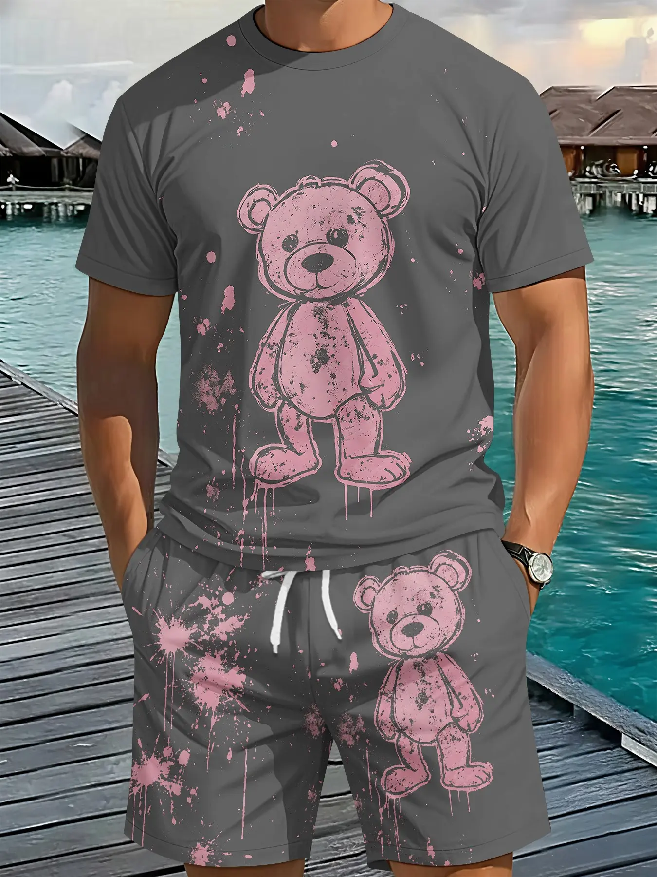 Men's two-piece set of short-sleeve top and shorts, featuring pink splashed distressed bear drip graffiti prints on a dark grey base. This sweet yet retro men’s outfit adopts 3D digital printing. It is comfortable, loose, breathable sportswear for casual