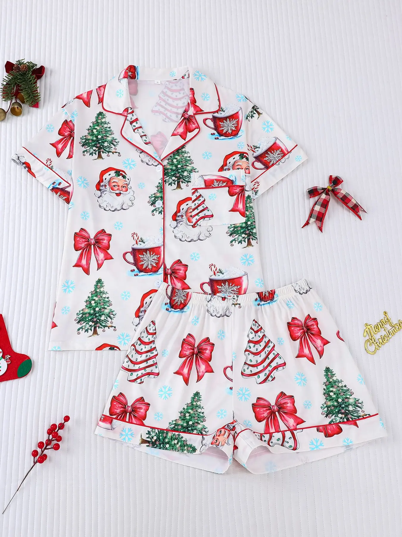 Women's 2-piece Christmas pajama set, white base with Santa, Christmas trees, bows and hot cocoa prints. Fresh cozy festive style with red contrast trim. Lapel short sleeve top with pocket, elastic waist shorts, soft comfy loungewear for all-season wear