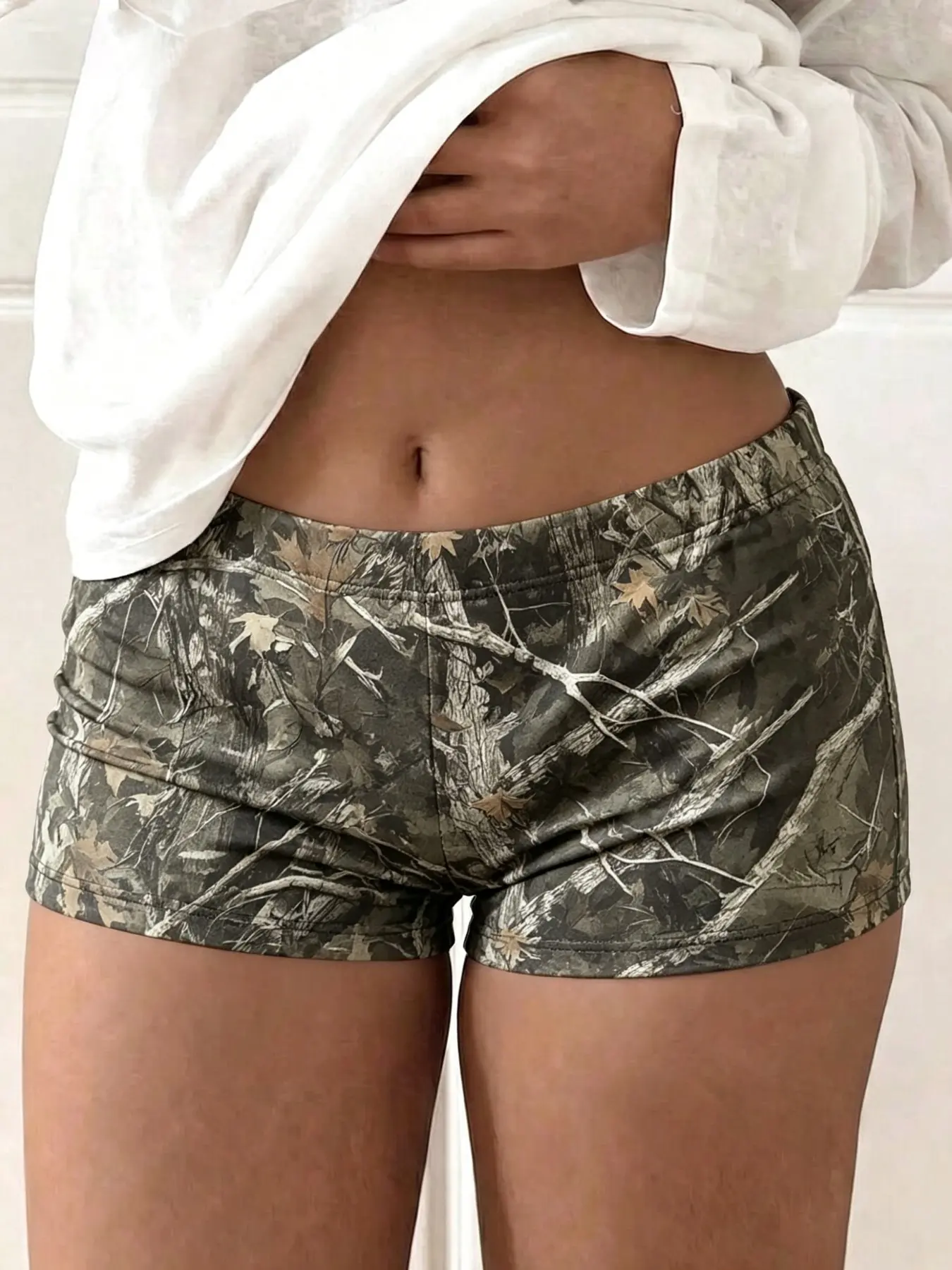 Y2K millennium style sexy micro shorts, Camouflage athletic shorts, tree pattern camouflage all-over print, low-rise tight fit with elastic waist, comfortable skin-friendly fabric, suitable for summer sports and fitness, daily leisure, party wear