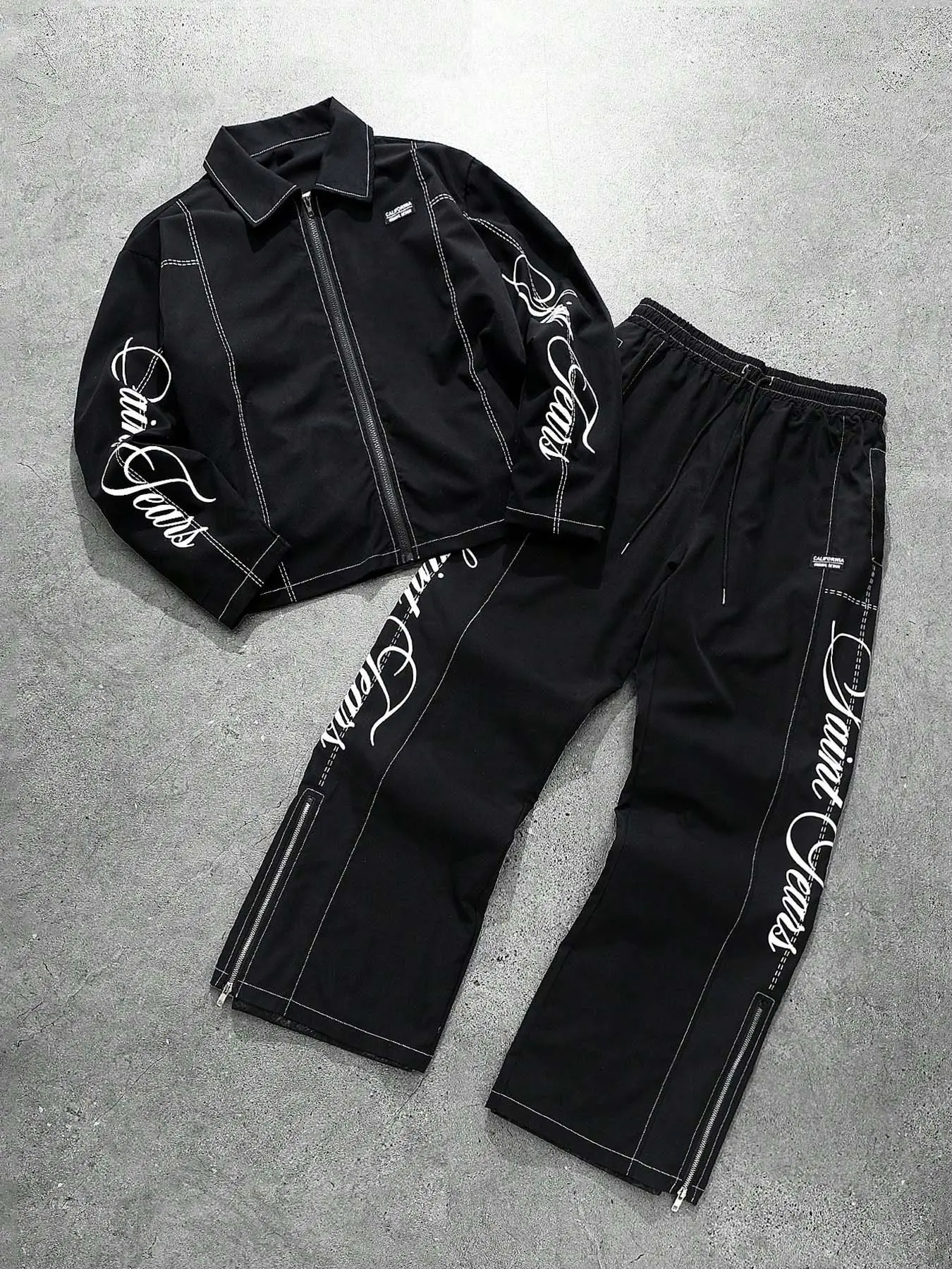 Men's two-piece black set, featuring a zip-up jacket and black-and-white contrast stitched pants, with a cursive letter print. Made of soft and comfortable fabric, perfect for skateboarding, everyday streetwear, and hip-hop parties. Clothing Sets