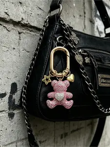Sparkling pink rhinestone teddy bear keychain with star and heart pendants. Cute crystal bear bag charm for women, equipped with golden spring ring. Perfect gift for Valentine's Day and birthdays.