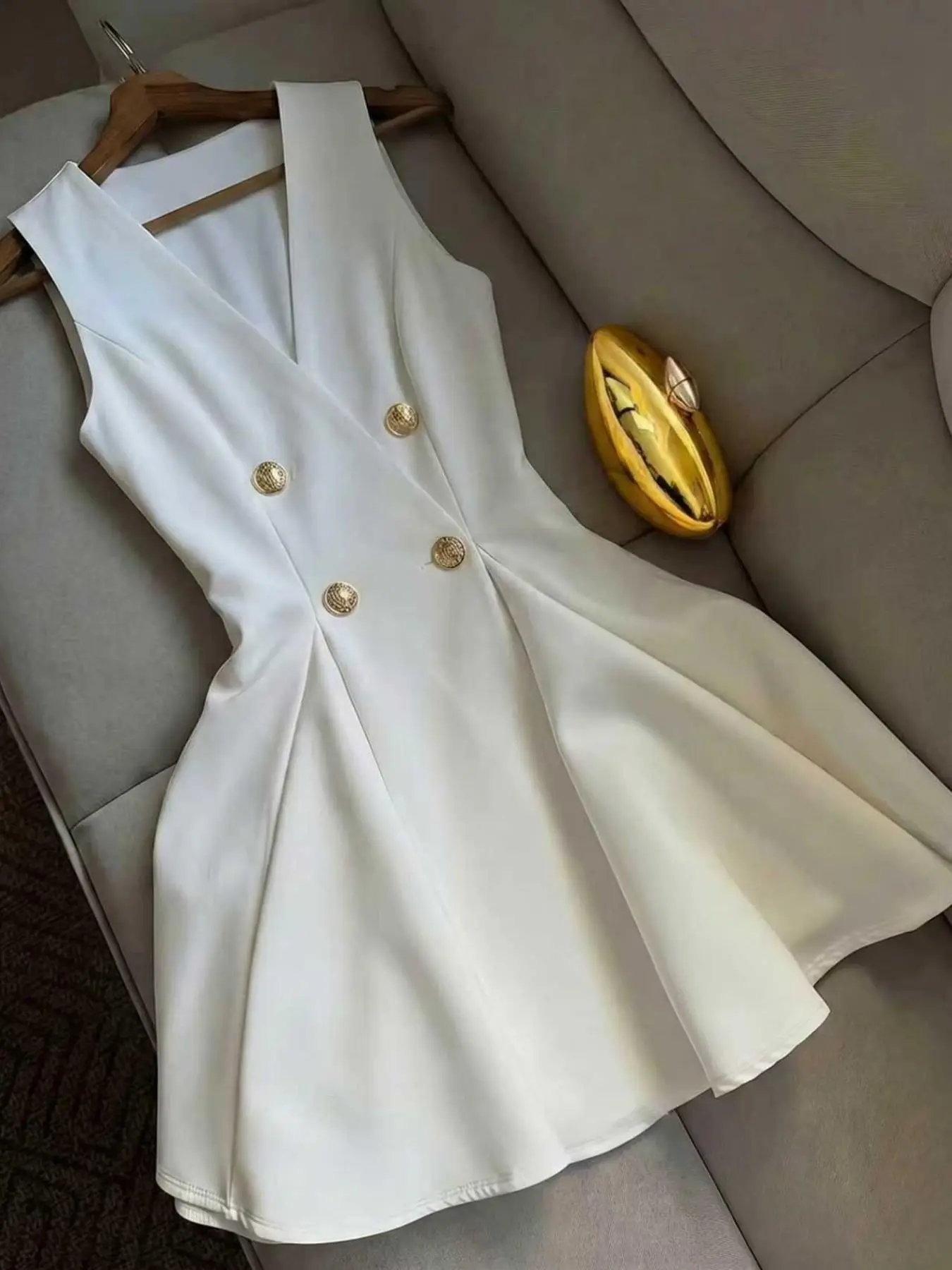 White sleeveless double-breasted blazer dress featuring an elegant and chic sophisticated V-neck, a waist-cinching fit, and a flared A-line skirt—suitable for the workplace and semi-formal occasions. Elegance