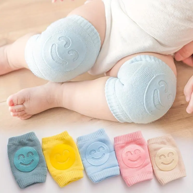 Knee and elbow pad set featuring a cute smiley face design; non-slip, phthalate-free, and unisex safety gear for crawling.
