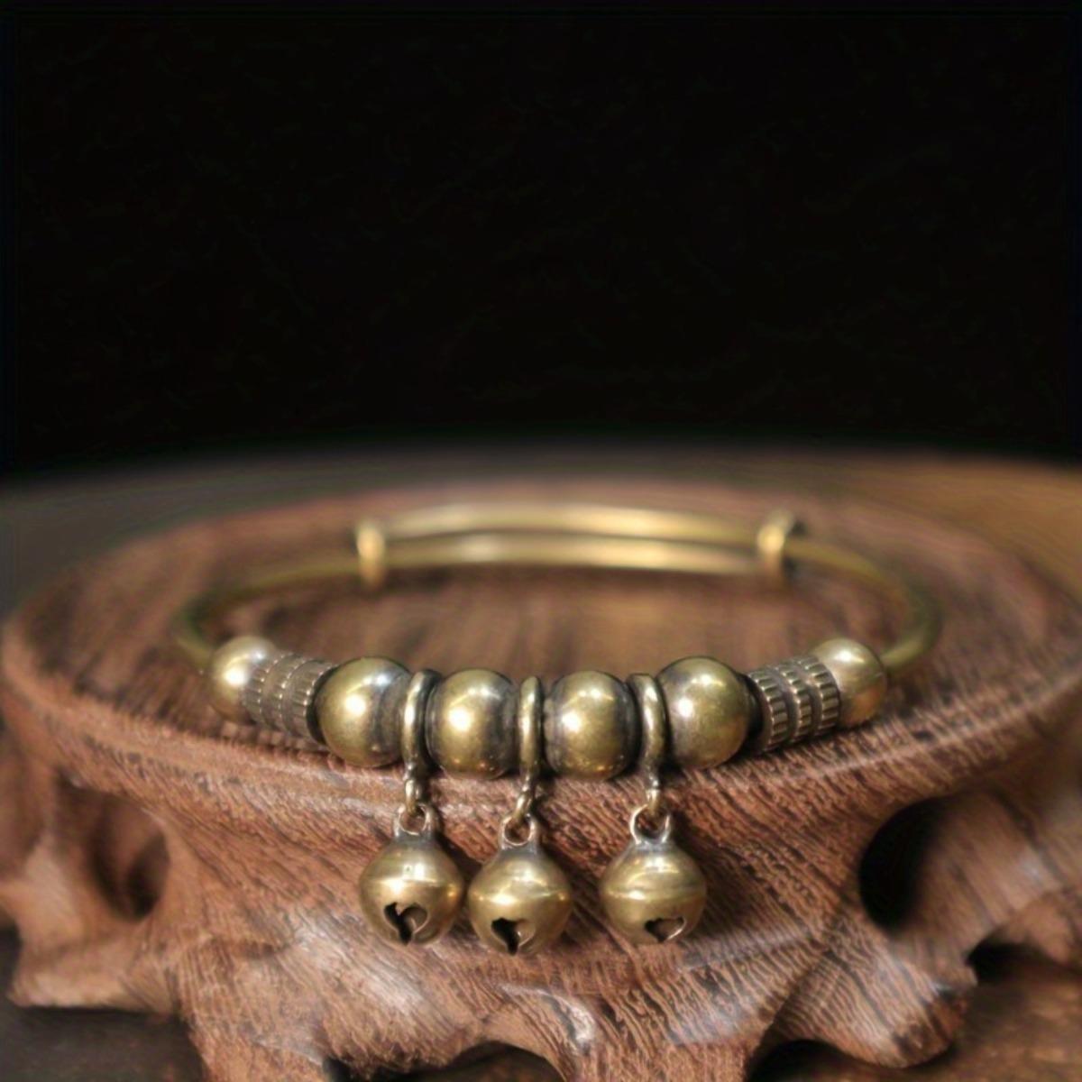 A vintage-style geometric bell braceletâan accessory designed to soothe the mind and alleviate stress. Featuring a convenient push-and-pull adjustable design, this bracelet symbolizes wealth and good fortune, serving as a vessel for heartfelt blessings. A vintage-style geometric bell braceletâan accessory designed to soothe the mind and alleviate stress. Featuring a convenient push-and-pull adjustable design, this bracelet symbolizes wealth and good fortune, serving as a vessel for heartfelt blessings.