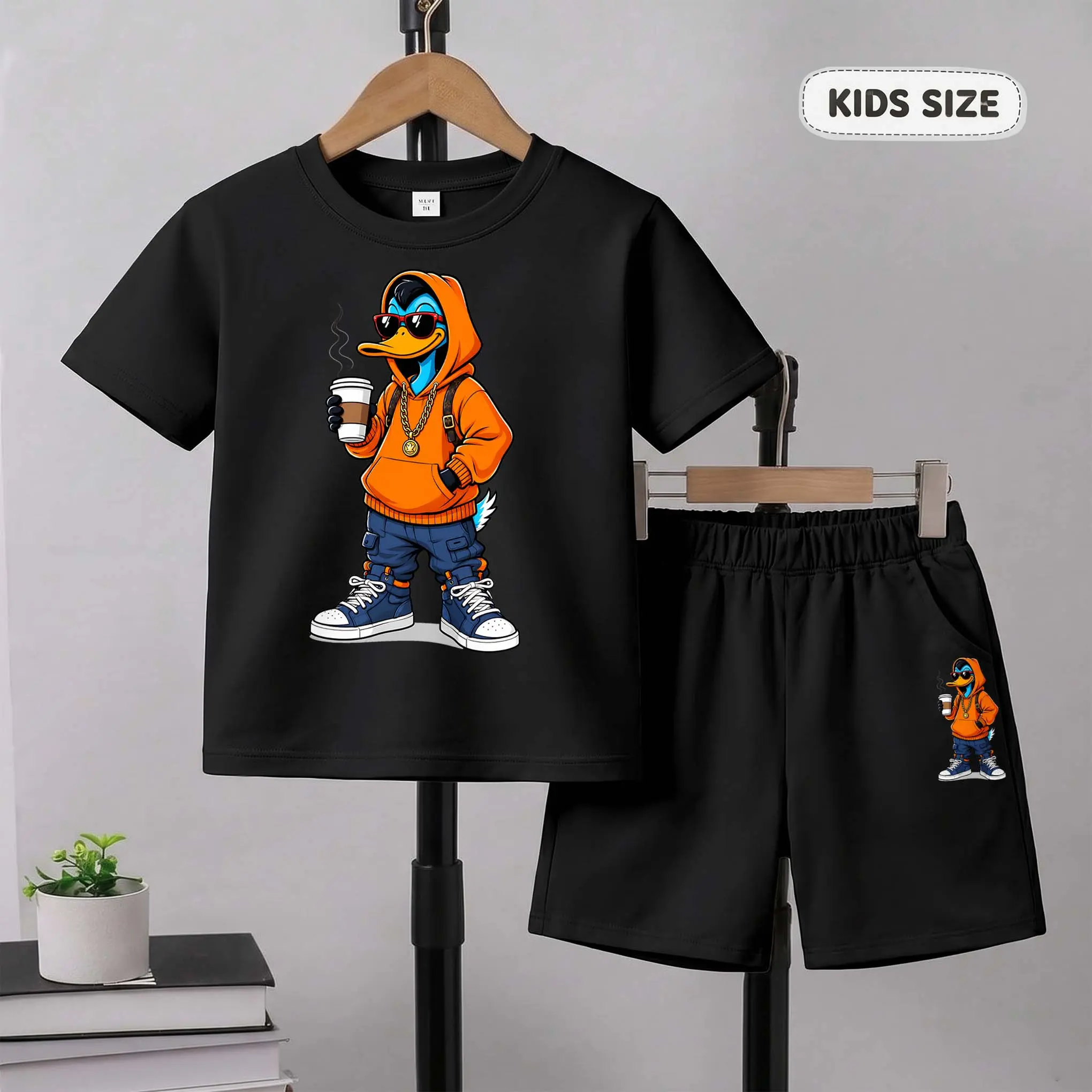 Kids’ A Cartoon Duck Wearing An Orange Hoodie. Cartoon Dog Print Short-Sleeve T-Shirt And Shorts Set—Casual Summer Kids' Clothing. This Round-Neck Outfit Combination Is Perfect For Everyday Wear And Outdoor Play.