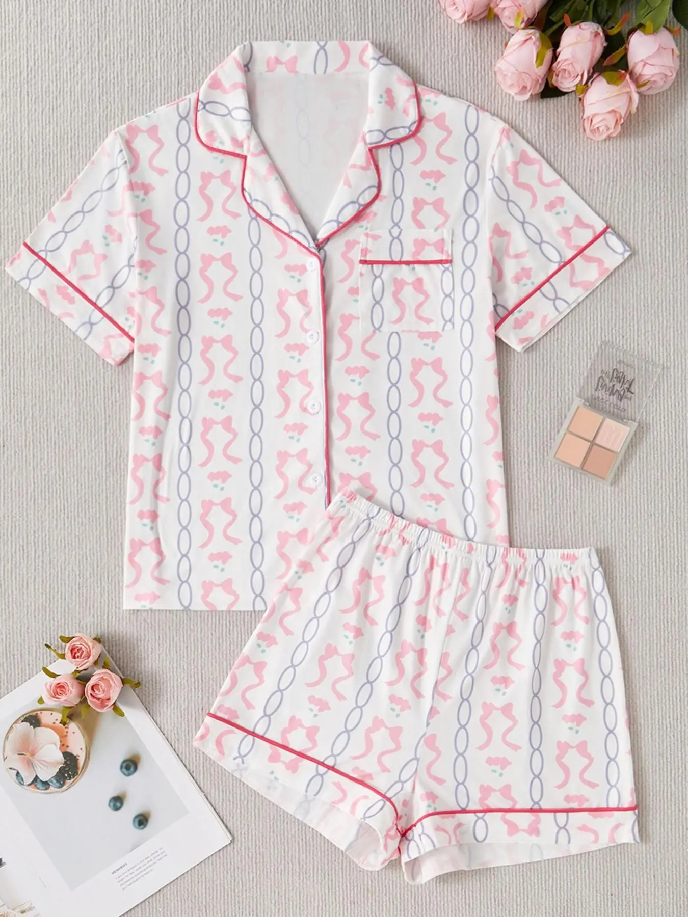 Two-piece women's pajamas set, featuring chain and bowknot prints, suitable for outer wear as loungewear, Nightwear. It includes a comfortable turtleneck button-up short-sleeved shirt and loose elastic shorts, Matching pajama set