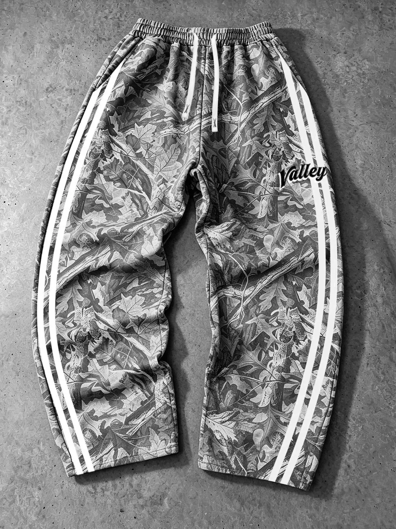 Men's Real-Tree leaf black-and-white camouflage print wide-leg sweatpants, Casual athletic sweatpants, unisex, with double white side stripes and VALLEY graphic letter print, drawstring pockets, loose street-style casual full-length sweatpants