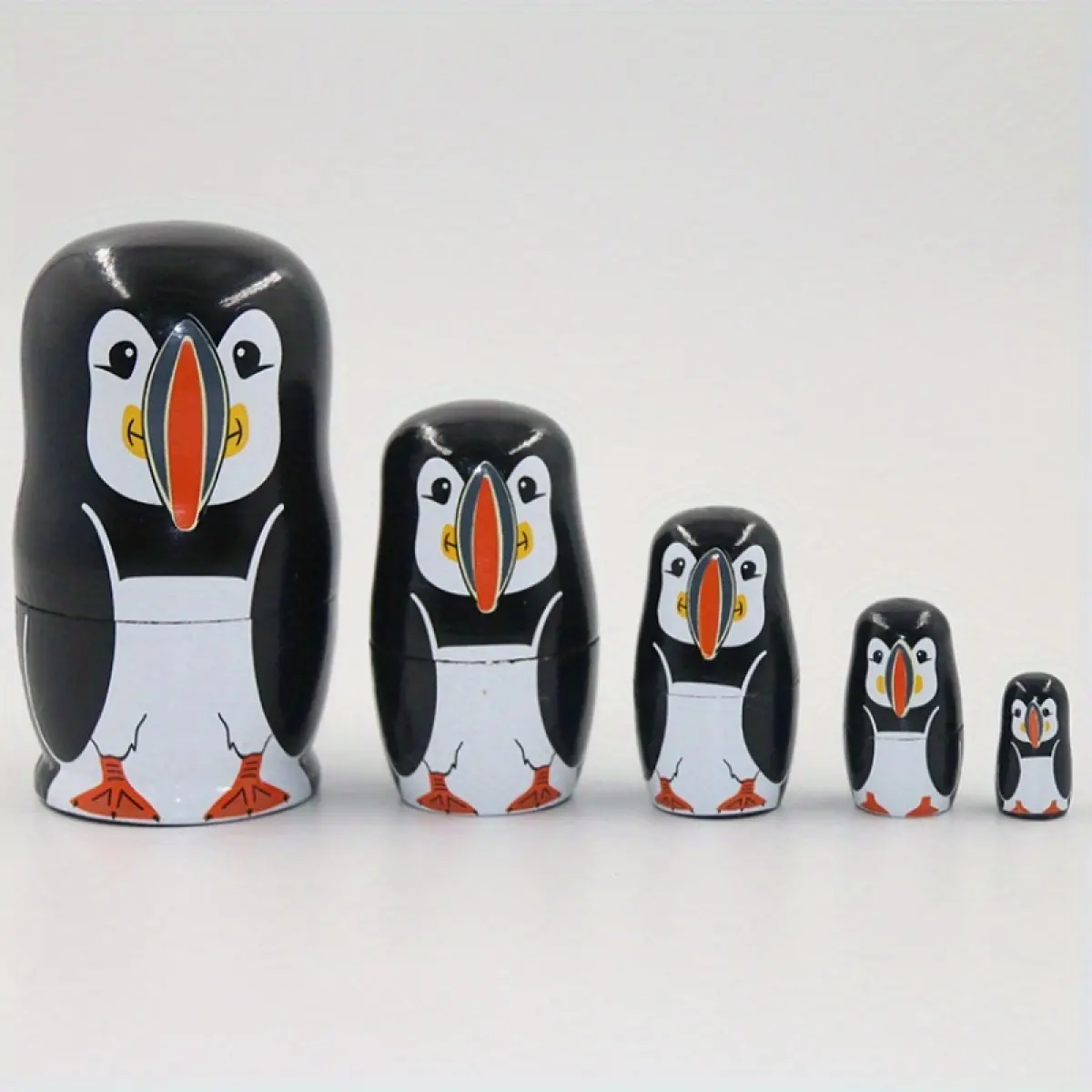 Russian nesting doll with five layers, cute and silly little penguin wooden crafts, ornaments, toys, gifts