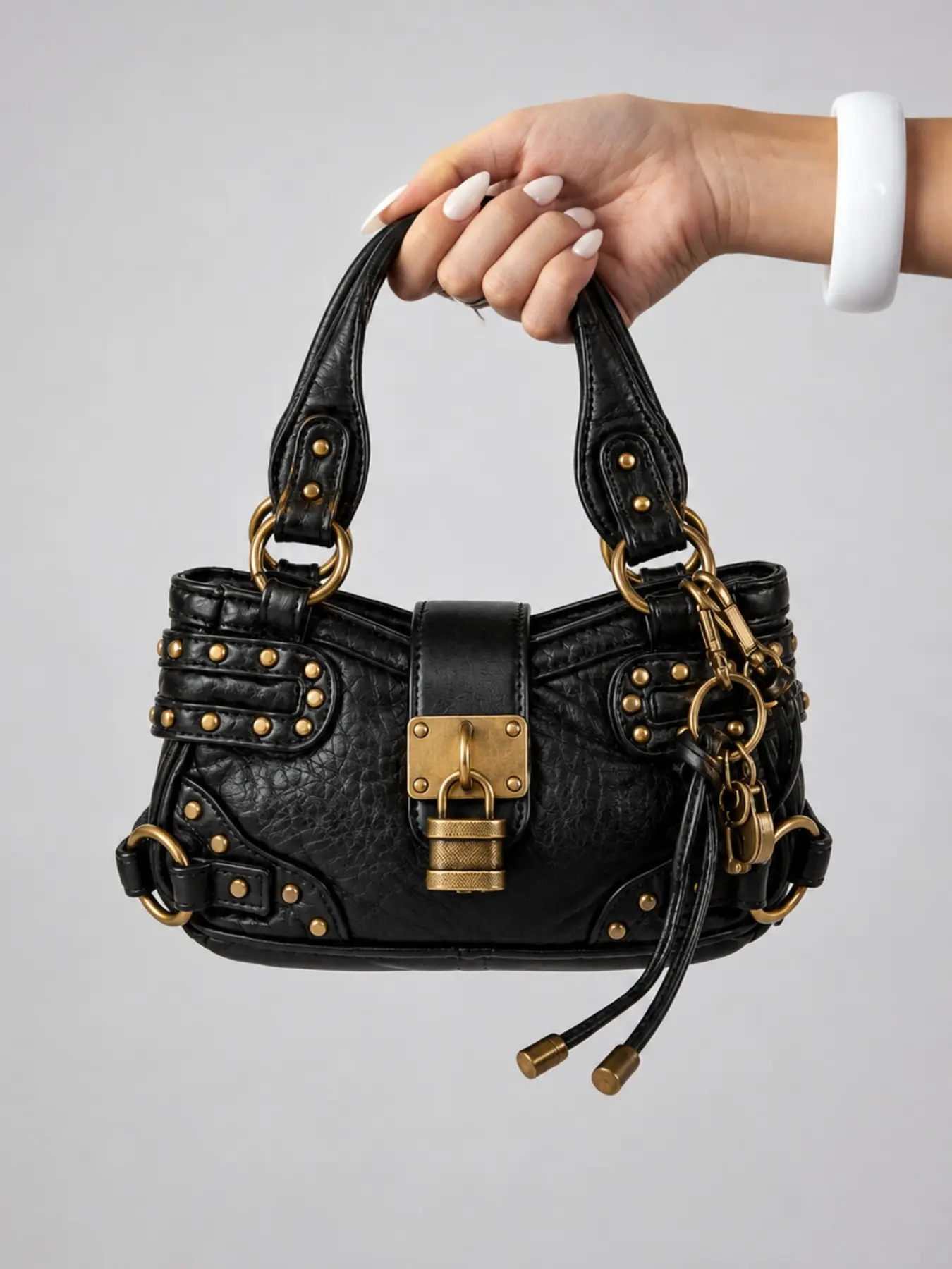 Y2K punk motorcycle shoulder bag, retro studded mini crossbody bag, trendy street style tote bag, essential small phone bag for everyday wear.