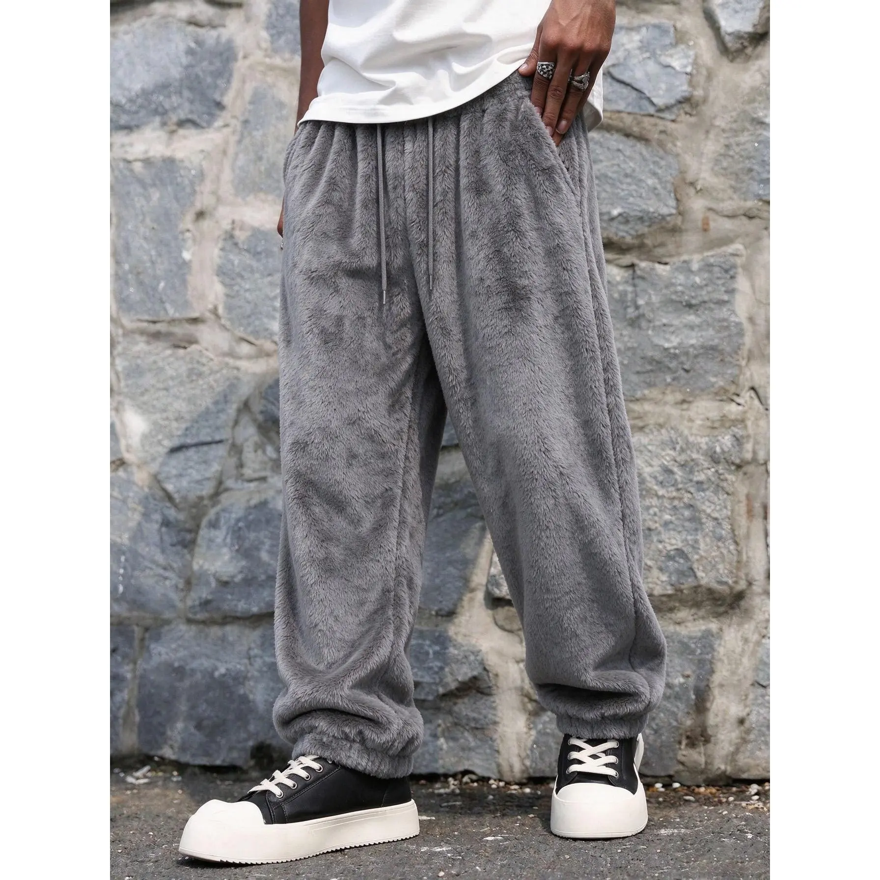 Men fuzzy plush casual pants, elastic waist with drawstring design, loose wide leg silhouette, soft fluffy fabric, trendy streetwear trousers for daily outdoor styling.
