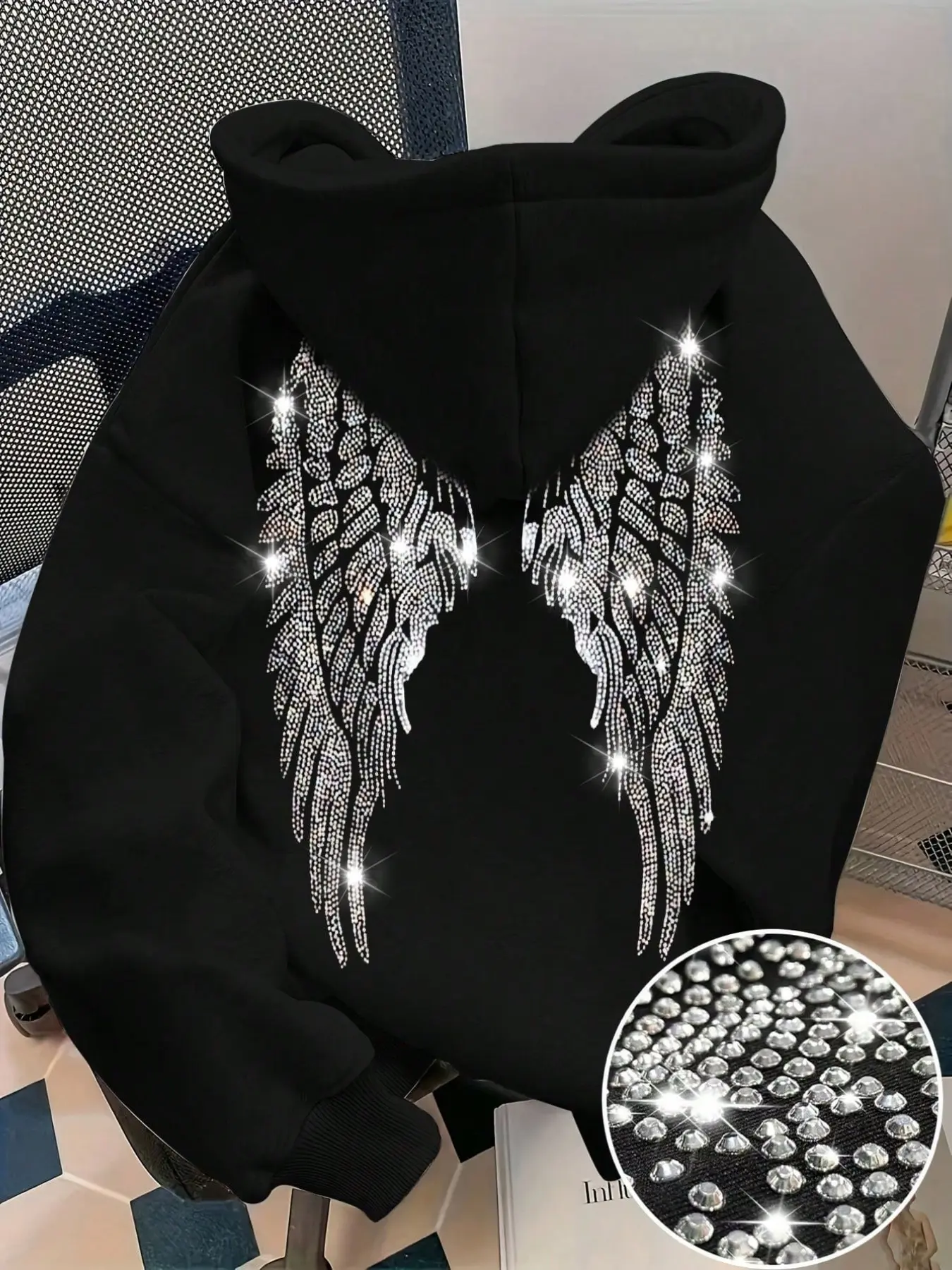 Women Men Black Hoodie With Bling Rhinestone Angel Wings On Back, loose oversized fit with drawstring hood and kangaroo pocket. Soft thick sweatshirt fabric, trendy Y2K street style, great for casual daily outfits in autumn and winter seasons