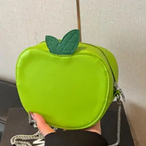 Nifty three-dimensional Apple chain messenger bag, red and green. Smooth PU leather with delicate leaf decoration, metal thin chain length to adapt to multi-body shape. The interior can easily fit a small phone, lipstick, and other everyday essentials, le
