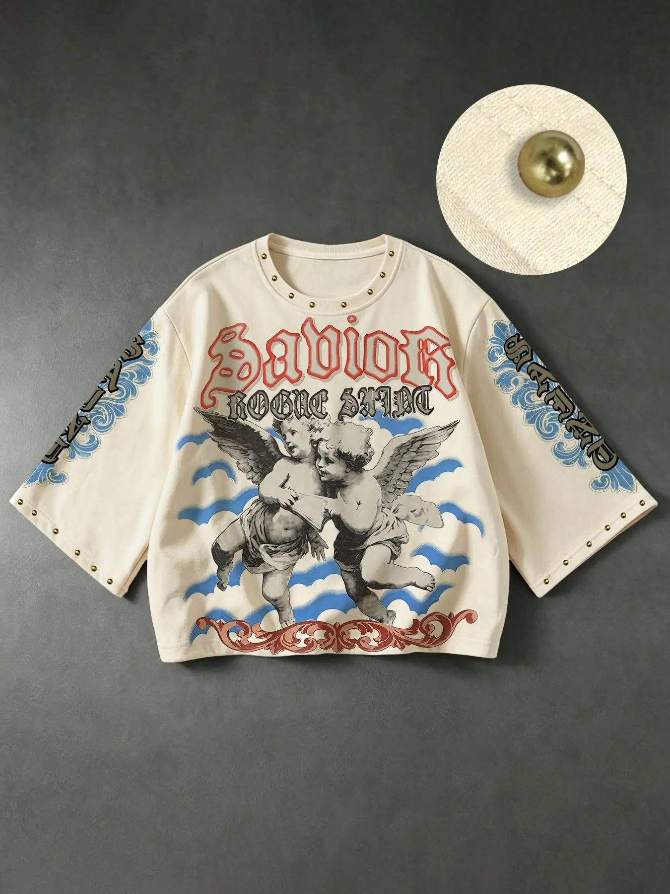 Two little angels embracing auspicious clouds. Savior Gothic lettering, ROGUE SAINT slogan print, gold studded trim, 3/4 sleeve top, loose fit, short, round neck, casual, unisex, suitable for everyday street style and trendy outings. Casual Everyday Tee