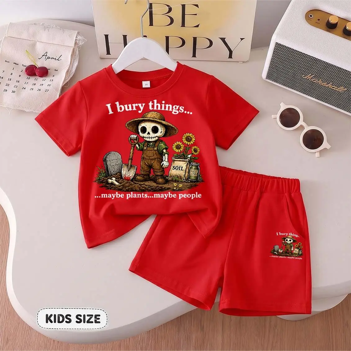 Kids’ “I Bury Things... Maybe Plants... Maybe People” Cartoon Print Short-Sleeve T-Shirt And Shorts Set—Casual Summer Kids' Clothing. This Round-Neck Outfit Combination Is Perfect For Everyday Wear And Outdoor Play.