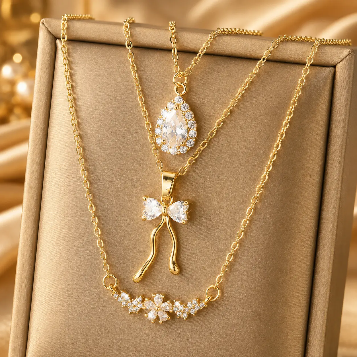 Best Sellers Necklace Bundle 3-Piece Gold Tone Layered Necklace Set for Women, Coquette Bow, Floral Crystal Bar and Teardrop Pendant Necklaces, Dainty Stackable Jewelry Bundle, Trendy Everyday Accessories and Gifts, Valentine’s Day and Birthday Gifts