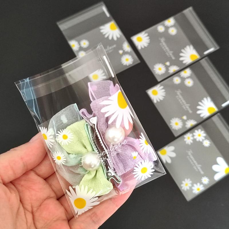 100pcs daisy print gift bag, transparent self-adhesive small packaging bag suitable for wedding return gifts, birthday tea parties, small gift packaging, independent packaging bags for biscuit baking all year round