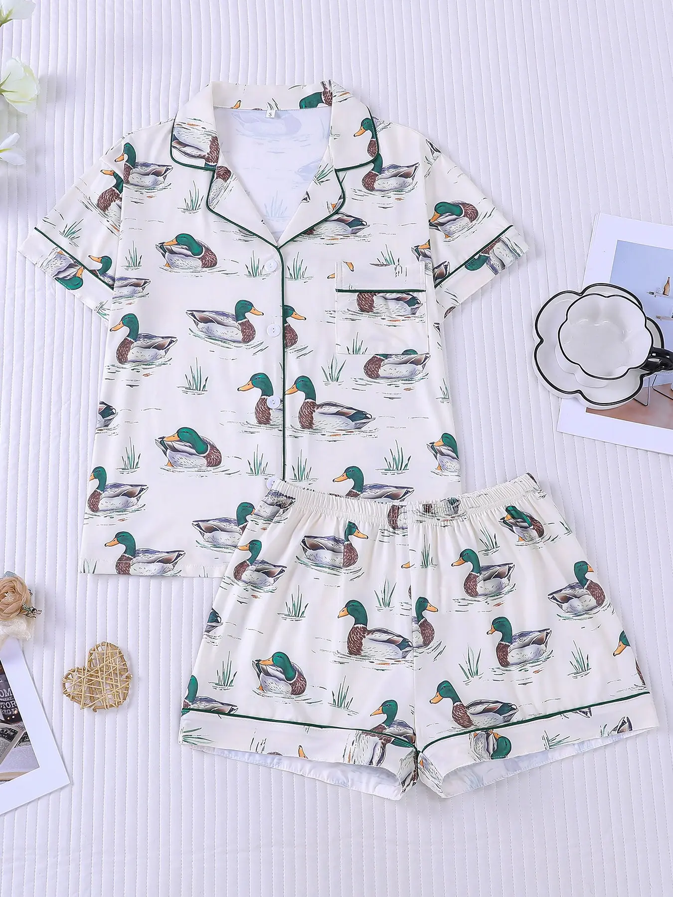 Women's 2-piece casual pajamas set with mallard duck & grass prints on cream base, fresh lakeside pastoral style, dark green contrast piping. Lapel top with chest pocket, soft elastic waist shorts, all-season casual loungewear for women