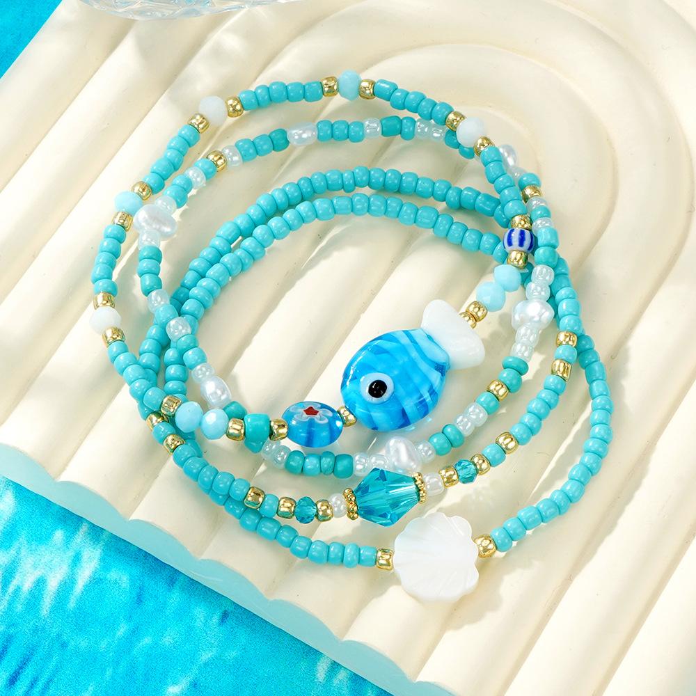 Niche & Whimsical Blue Glass Crystal Bracelet — Scallop Shell and Pearl-White Beaded Strand