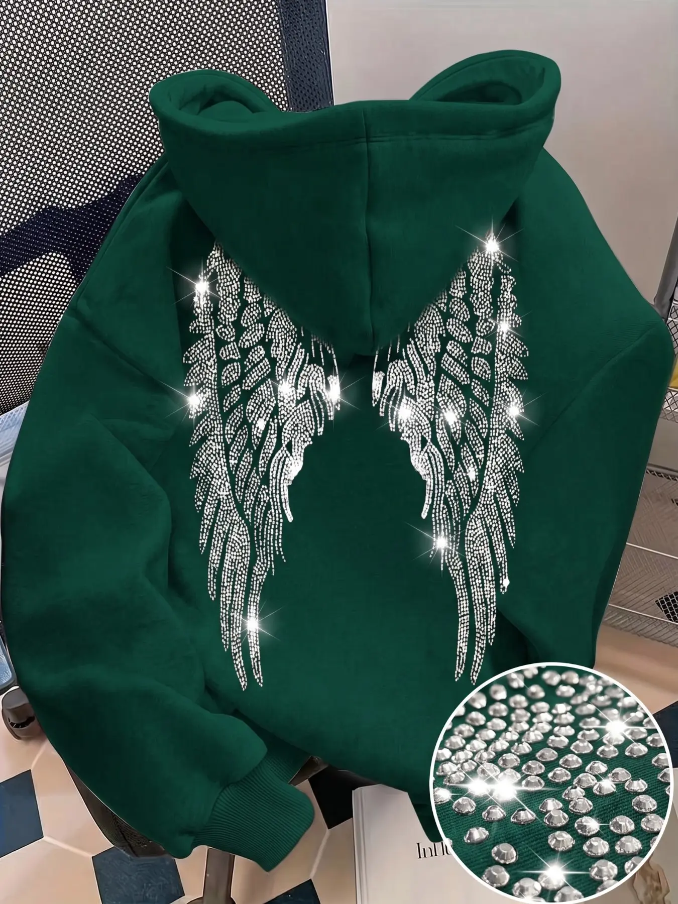 Loose-fit hooded pullover with shiny silver crystal wings, rhinestone-embellished casual top. This laid-back sweatshirt features American hip-hop and goth subculture styles, unisex and suitable as couple outfits.